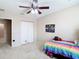 Comfortable bedroom with ceiling fan, double door closet, and cozy carpet at 1105 Canyon Oaks Dr, Brandon, FL 33510