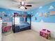 Themed bedroom features unique wall decor, a bunk bed, and playful design for a creative space at 1105 Canyon Oaks Dr, Brandon, FL 33510
