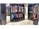 Walk-in closet featuring custom organization, mirrored doors, and ample storage space at 1105 Canyon Oaks Dr, Brandon, FL 33510