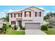 Charming two-story home with red shutters, a well-manicured lawn, and a two-car garage at 1105 Canyon Oaks Dr, Brandon, FL 33510
