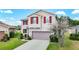 A lovely two-story home with red shutters and well-maintained landscaping at 1105 Canyon Oaks Dr, Brandon, FL 33510