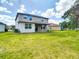 Spacious backyard with a two story home featuring a covered patio at 1105 Canyon Oaks Dr, Brandon, FL 33510