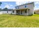 Two-story home exterior with a covered patio and a spacious yard at 1105 Canyon Oaks Dr, Brandon, FL 33510