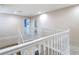 Upstairs hallway features carpet flooring and white railings, leading to bedrooms and bathrooms at 1105 Canyon Oaks Dr, Brandon, FL 33510