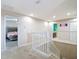 Bright hallway with carpet floors and white railings, leading to bedrooms and a bathroom upstairs at 1105 Canyon Oaks Dr, Brandon, FL 33510