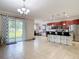 Bright living space with neutral tile flows into an open kitchen with granite counters and stainless appliances at 1105 Canyon Oaks Dr, Brandon, FL 33510