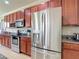 Updated kitchen featuring dark wood cabinets, stainless steel appliances, and granite countertops at 1105 Canyon Oaks Dr, Brandon, FL 33510