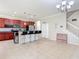 Kitchen view features tile flooring, a breakfast bar with seating, and modern stainless steel appliances at 1105 Canyon Oaks Dr, Brandon, FL 33510