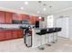 A kitchen with granite counters, stainless steel appliances, a wine rack, a pantry, and a breakfast bar at 1105 Canyon Oaks Dr, Brandon, FL 33510