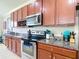 Updated kitchen featuring dark wood cabinets, stainless steel appliances, and granite countertops at 1105 Canyon Oaks Dr, Brandon, FL 33510