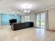 Open living room features tile flooring, a blue accent wall, comfortable seating, and patio door access at 1105 Canyon Oaks Dr, Brandon, FL 33510