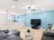 Bright living room boasts neutral tile flooring, a blue accent wall, and a comfortable seating area at 1105 Canyon Oaks Dr, Brandon, FL 33510