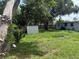 View of a shed in the backyard featuring lush grass and tall shade trees at 1204 E Camellia Dr, Brandon, FL 33510