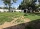 Spacious backyard featuring a shed with green grass, partially fenced and a partially shaded area at 1204 E Camellia Dr, Brandon, FL 33510