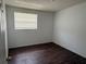 Simple bedroom with wood-look floors, neutral paint, and natural light at 1204 E Camellia Dr, Brandon, FL 33510