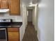 Hallway view from the kitchen, featuring wood-look flooring and multiple doors at 1204 E Camellia Dr, Brandon, FL 33510