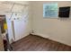 Laundry room with shelving, wood look flooring, and a window for natural light and ventilation at 1204 E Camellia Dr, Brandon, FL 33510