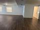 Bright living room with modern wood-look flooring, neutral paint, and natural light from large windows at 1204 E Camellia Dr, Brandon, FL 33510
