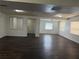 Open living room features wood-look flooring, neutral paint, and natural light from multiple windows at 1204 E Camellia Dr, Brandon, FL 33510