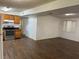 View of the living room from kitchen, featuring wood-look flooring, neutral paint, and kitchen at 1204 E Camellia Dr, Brandon, FL 33510
