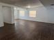 Open-concept living space with modern wood flooring and neutral walls with natural light throughout at 1204 E Camellia Dr, Brandon, FL 33510