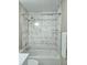Clean bathroom featuring white marble-style tiled shower and tub at 12121 Wildbrook Dr, Riverview, FL 33569