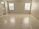 Spacious bedroom with neutral walls, two windows, and tile flooring at 12121 Wildbrook Dr, Riverview, FL 33569