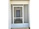 Inviting front porch with tiled floor and view of the front door for added security and curb appeal at 12121 Wildbrook Dr, Riverview, FL 33569