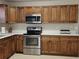 Spacious kitchen features stainless steel appliances and wooden cabinetry at 12121 Wildbrook Dr, Riverview, FL 33569