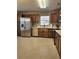 Bright kitchen features stainless steel appliances, tile flooring, and wooden cabinetry at 12121 Wildbrook Dr, Riverview, FL 33569