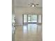 Bright and airy living room boasts tile floors, slider to patio, and a ceiling fan for added comfort at 12121 Wildbrook Dr, Riverview, FL 33569