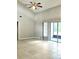Spacious living room featuring a ceiling fan and sliding doors to the outdoor patio at 12121 Wildbrook Dr, Riverview, FL 33569