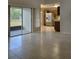 Open concept living area with tile flooring, sliders to back yard and adjacent kitchen with stainless appliances at 12121 Wildbrook Dr, Riverview, FL 33569