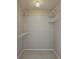 A walk-in closet with neutral walls, tile flooring, and built-in wire shelving at 12121 Wildbrook Dr, Riverview, FL 33569