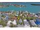 Charming aerial view of the property surrounded by lush palm trees near waterfront and a pool at 13123 4Th E St, Madeira Beach, FL 33708