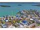 Lovely aerial view of the residence surrounded by lush landscaping near the tranquil waterfront at 13123 4Th E St, Madeira Beach, FL 33708