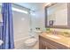 Functional bathroom with a granite vanity, shower-tub combo, and tiled floors at 1666 Meadow Oak Ln, Tarpon Springs, FL 34689