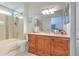 Well-lit bathroom featuring a vanity with storage, a bathtub, and neutral tile at 1666 Meadow Oak Ln, Tarpon Springs, FL 34689