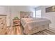 Cozy bedroom with a decorative bed, wooden floors, and ample natural light at 1666 Meadow Oak Ln, Tarpon Springs, FL 34689