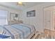Comfortable bedroom featuring a television, wood floors, and attached bathroom at 1666 Meadow Oak Ln, Tarpon Springs, FL 34689