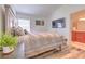 Inviting bedroom with neutral colors, hardwood floors, and a mounted television at 1666 Meadow Oak Ln, Tarpon Springs, FL 34689