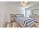 Bright bedroom with modern furniture, wood-look floors, and ceiling fan at 1666 Meadow Oak Ln, Tarpon Springs, FL 34689