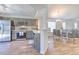 Modern kitchen with stainless steel appliances, gray cabinetry, wood-look flooring, and access to the dining area at 1666 Meadow Oak Ln, Tarpon Springs, FL 34689