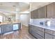 Bright kitchen featuring gray cabinetry, stainless steel appliances, and wood-look tile flooring at 1666 Meadow Oak Ln, Tarpon Springs, FL 34689