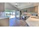Well-lit kitchen with stainless steel appliances, gray cabinets, and a sliding glass door leading to the pool area at 1666 Meadow Oak Ln, Tarpon Springs, FL 34689