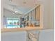 Stylish kitchen with stainless steel appliances, grey cabinets, a breakfast bar, and a view of the pool at 1666 Meadow Oak Ln, Tarpon Springs, FL 34689