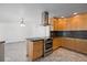 Functional kitchen with wood cabinets, stainless steel oven and granite countertops at 1720 Emerald Dr, Clearwater, FL 33756