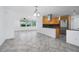 Bright kitchen featuring granite countertops, wooden cabinetry, and stainless steel appliances at 1720 Emerald Dr, Clearwater, FL 33756