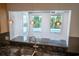 Kitchen view highlighting granite countertops and an open view to the pool at 1720 Emerald Dr, Clearwater, FL 33756