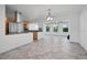 Modern kitchen with stainless steel appliances, granite countertops, and an adjacent dining area at 1720 Emerald Dr, Clearwater, FL 33756